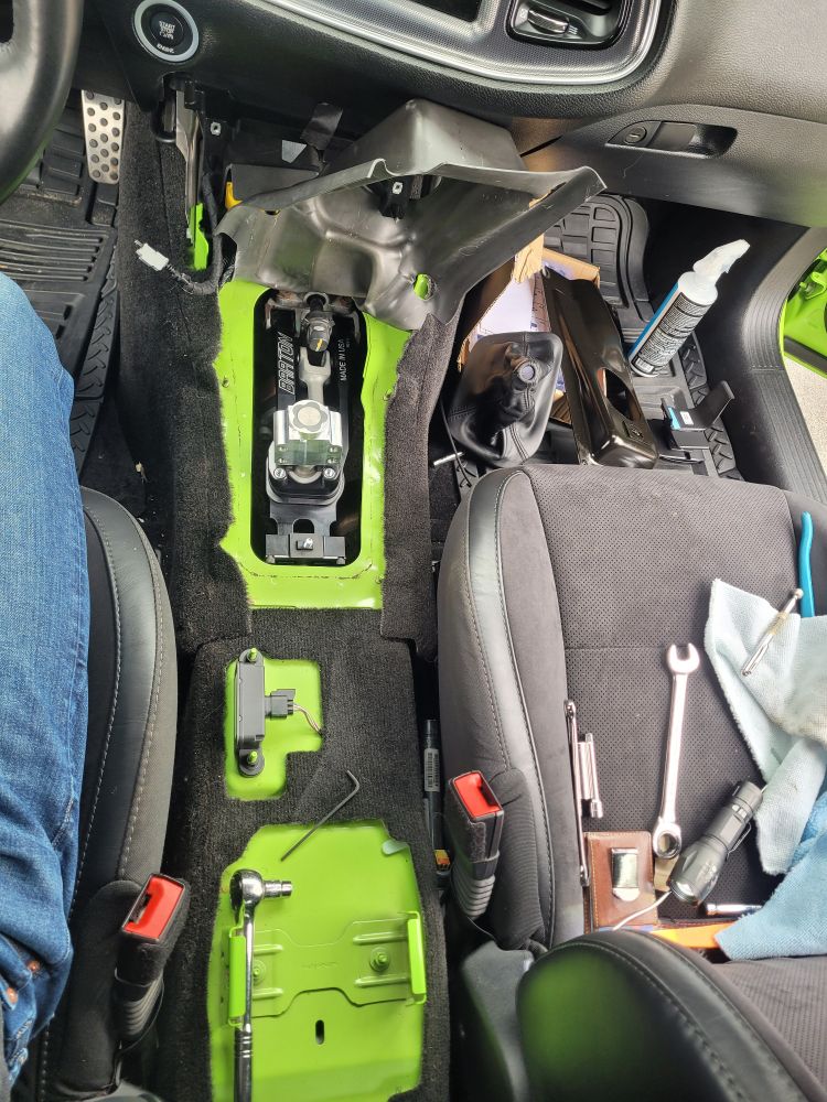 Center console and old assembly removed. After a long struggle with the rubber coated arms, the barton is finally in place