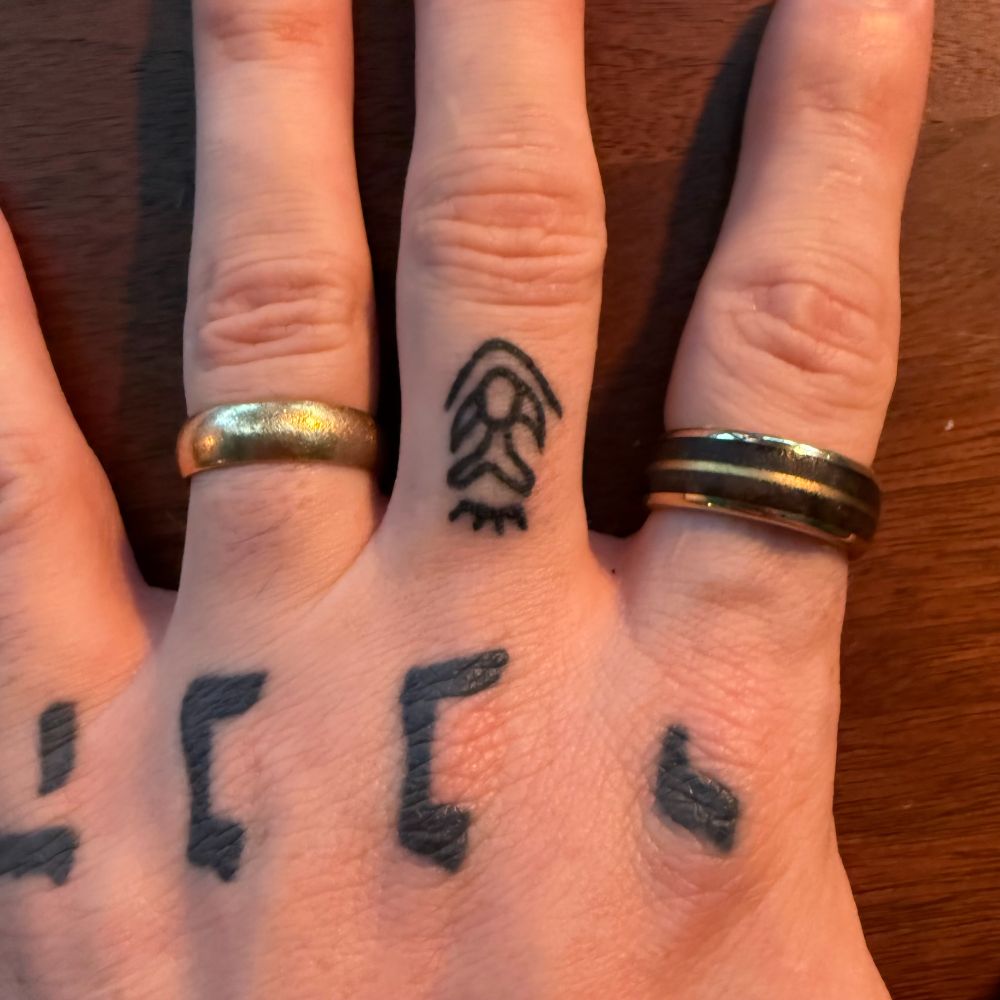 Ice Age Mummy tattoo on finger