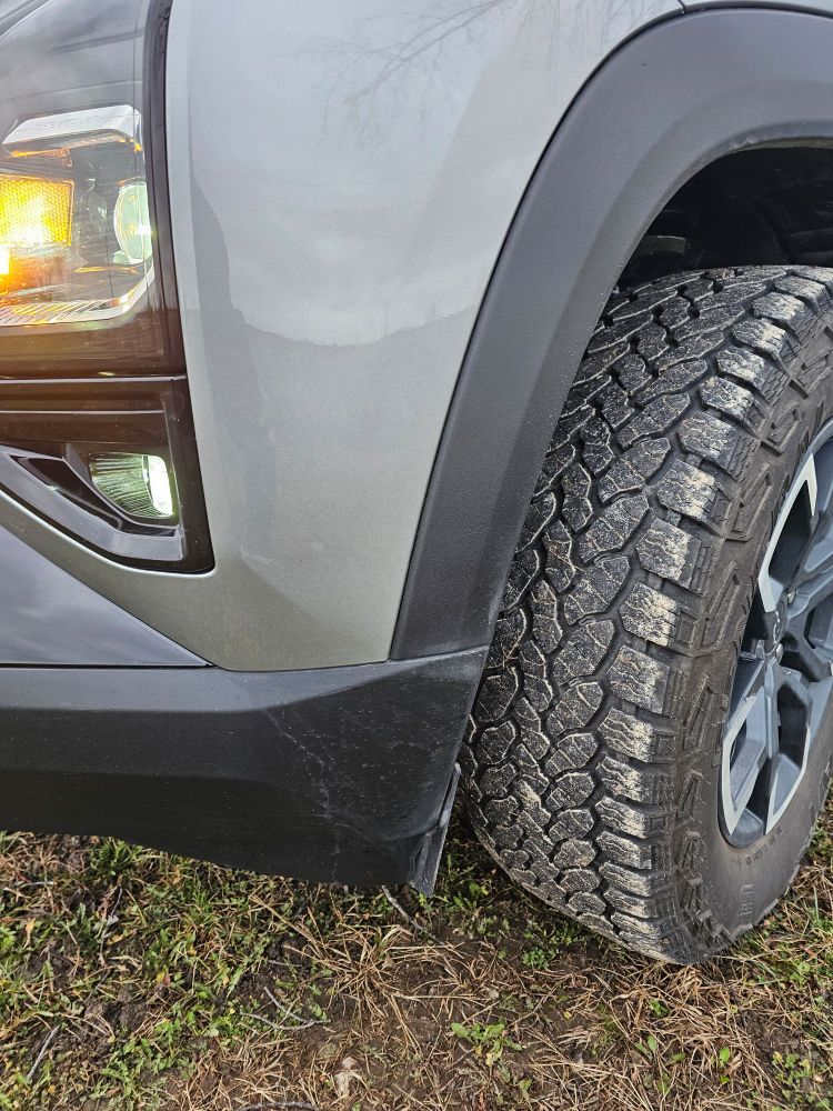 Photo of All Terrain front tire showing deep tread on front of Chevy Equinox. 