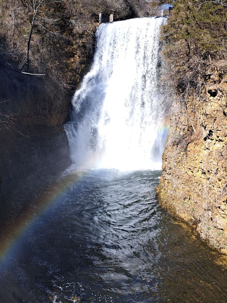 Picture of a waterfall with a rainbow