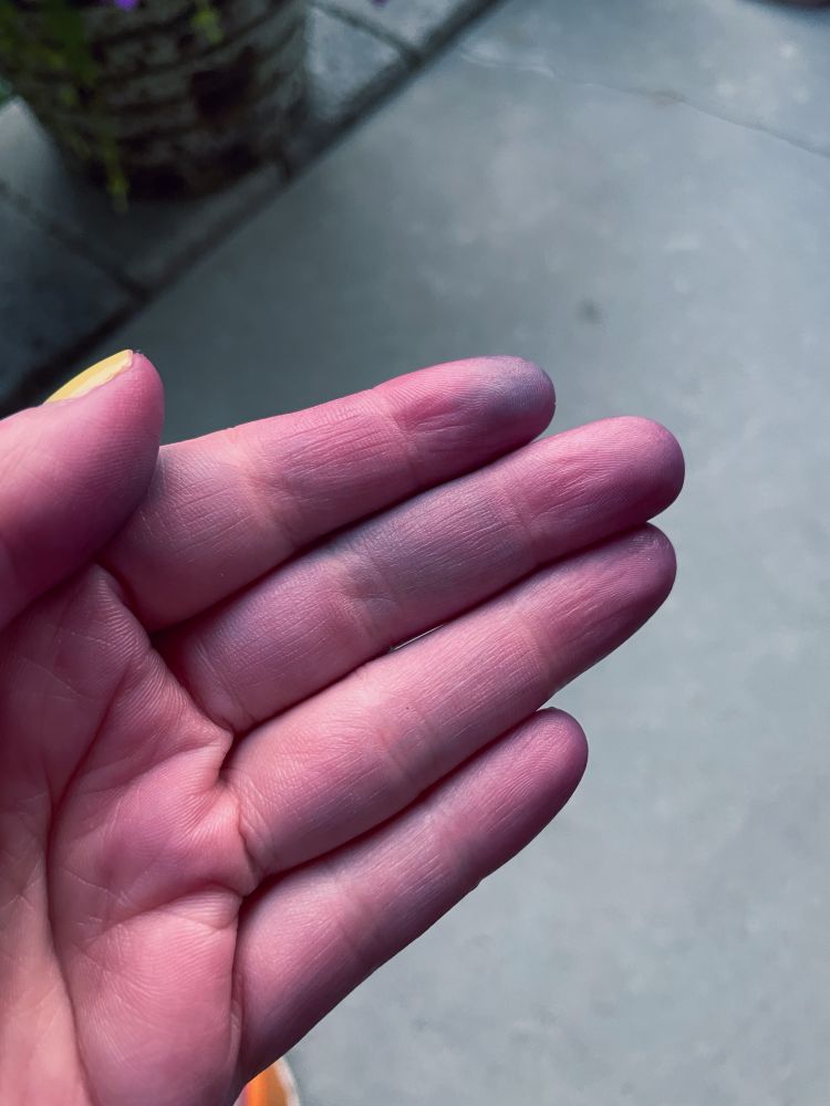 A hand but the fingers fade into a purplish blue…zombie fingers, if you will. 