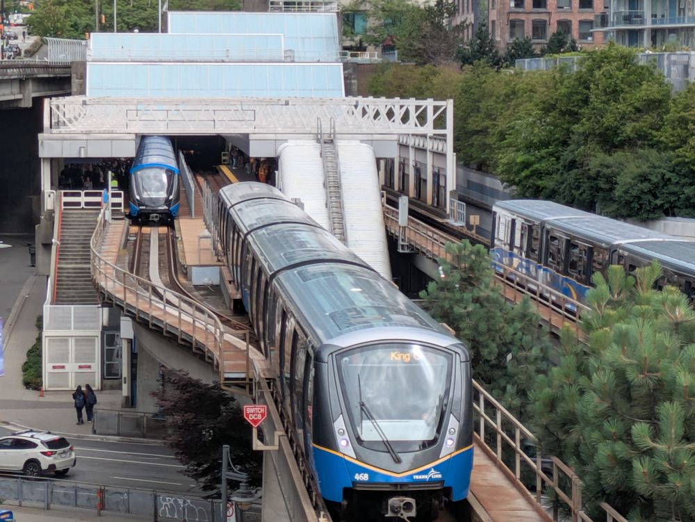 Three generations of trains at or approaching Stadium-Chinatown Station
