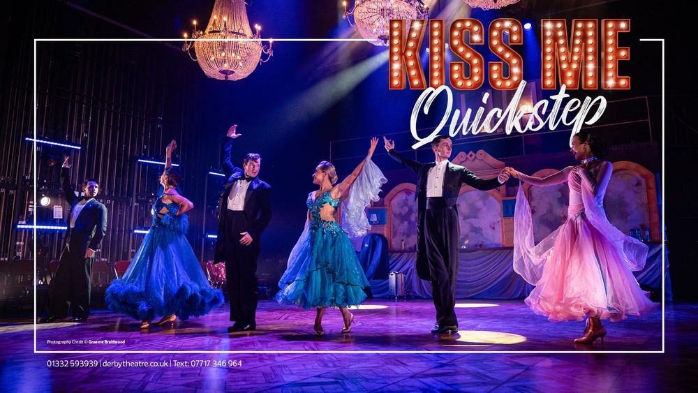 Cast members of Kiss Me Quickstep strike a triumphant pose mid-performance on a theatre stage bathed in dramatic purple and gold lighting. Dressed in elegant ballroom attire—tuxedos and sparkling gowns in shades of blue and pink—the dancers hold graceful arm positions under ornate chandeliers. The bold show title “Kiss Me Quickstep” is illuminated above them, with photography credited to Graeme Braidwood and contact info for Derby Theatre displayed at the bottom.