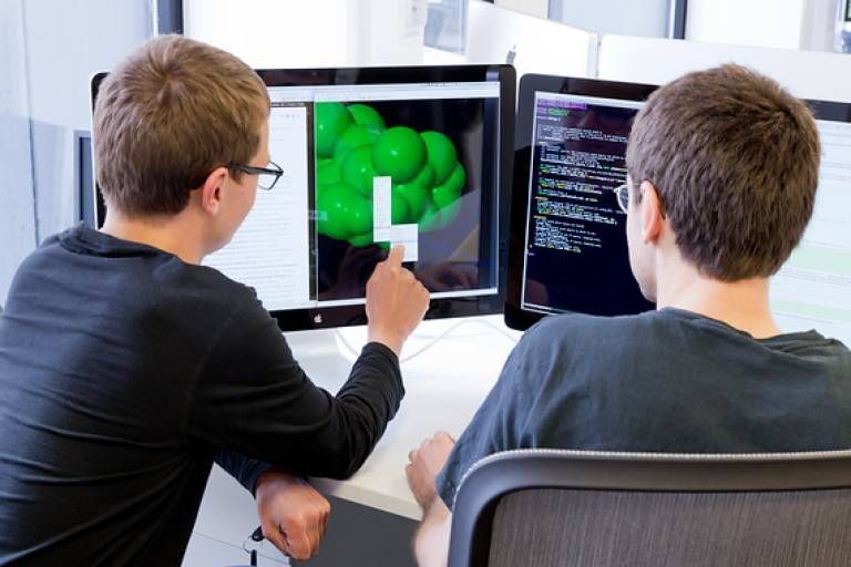 Two people looking at the screen