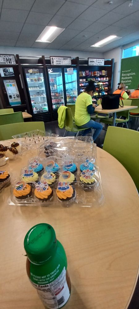 Chocolate cupcakes with orange and yellow frostings.