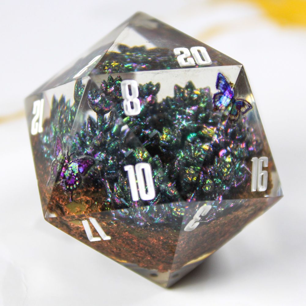 Photo of a d20 diorama with little succulent plants and holographic butterflies.