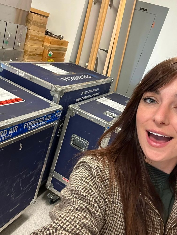 Weird lady with big blue boxes behind her (which in them holds a bunch of microscope stuff)