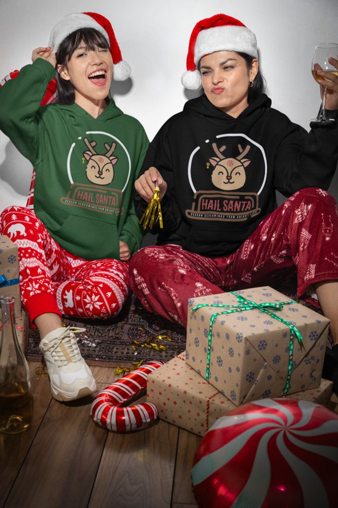 Two women wearing a dark green and black hoodies