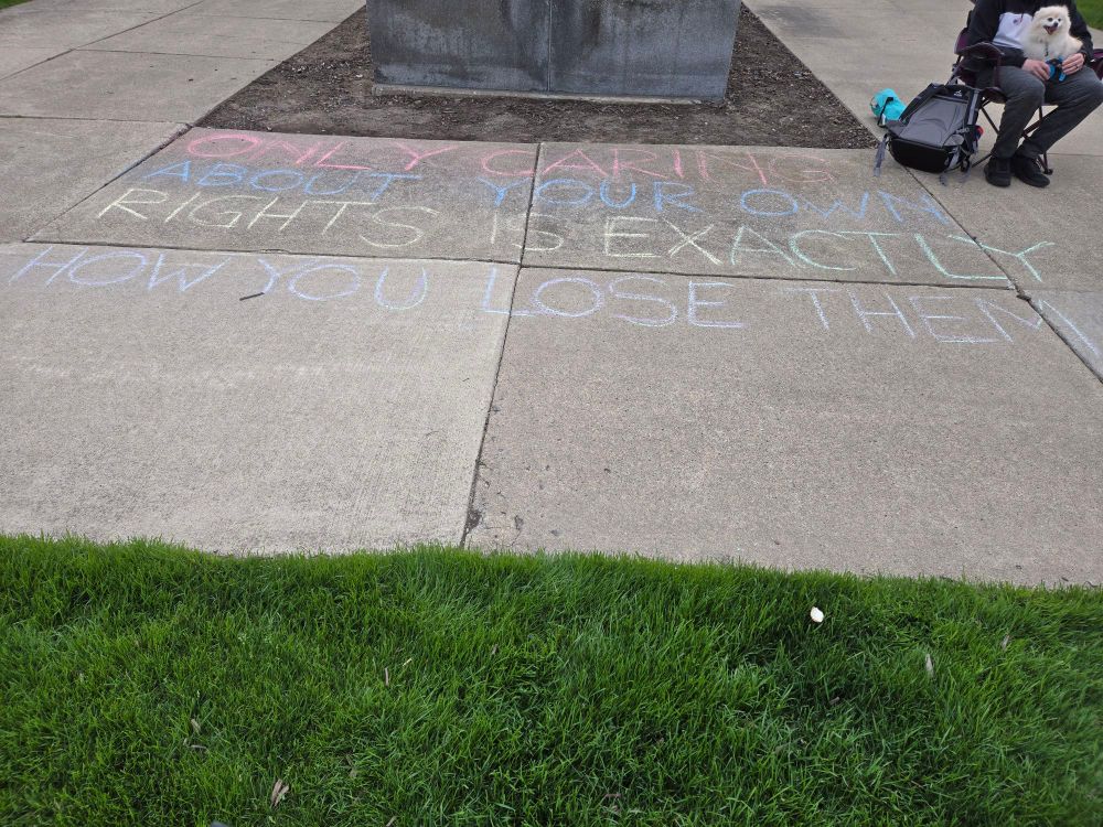 Chalk art that reads: "ONLY CARING ABOUT YOUR OWN RIGHTS IS EXACTLY HOW YOU LOSE THEM"