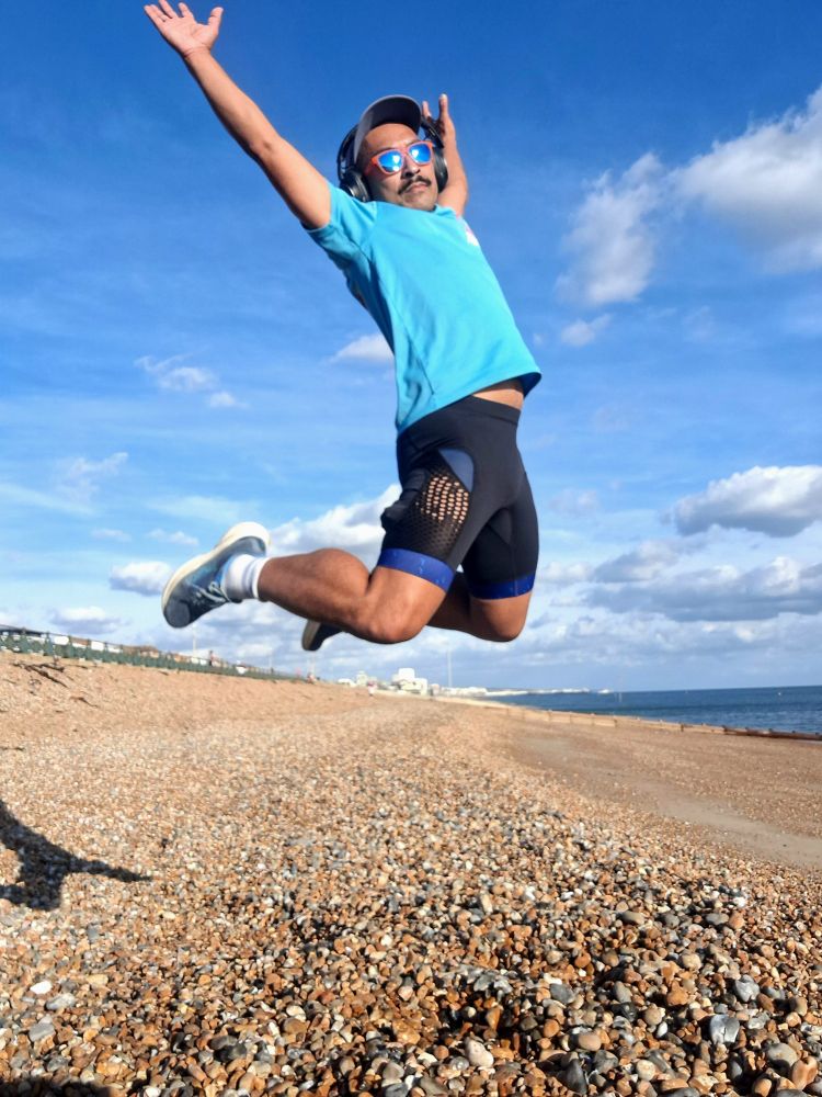 Selfie of me in mid-air jumping on Hove Beach 
