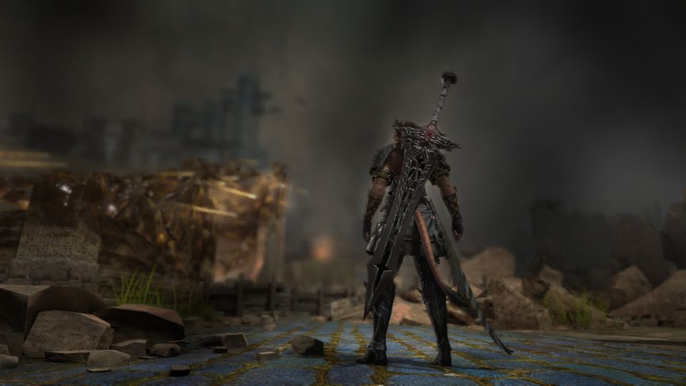 Low angle from behind as Dark Knight Clove stands on a broken road in Bozja, gazing up at the smoke-filled horizon, the shattered buildings blown into fused, crystallized aether by the force of the disastrous calamity that occurred here. 