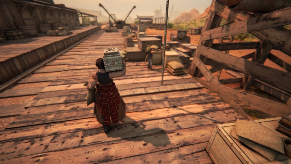 The camera moves down over the platform. A tall woman carrying a crate and burlap sack walks away from the camera, towards a hrothgar woman with her back to us.