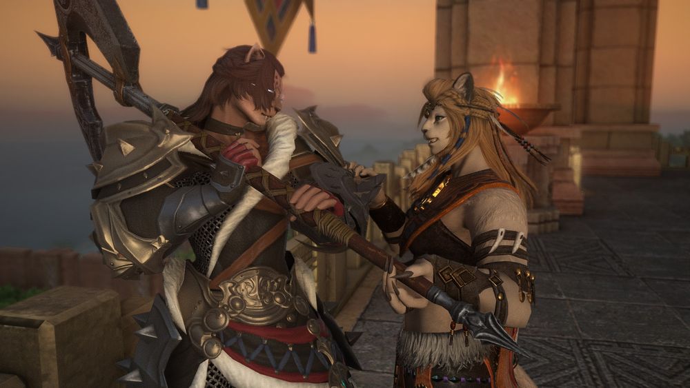 Clove just reached level 80 in Warrior and is showing off her new gear to Wuk Lamat who's got one hand on Clove's arm and the other in a suggestive manner on the haft of Clove's axe. It's a nice sunset sky and they're both smiling at each other like new lovers are wont to do