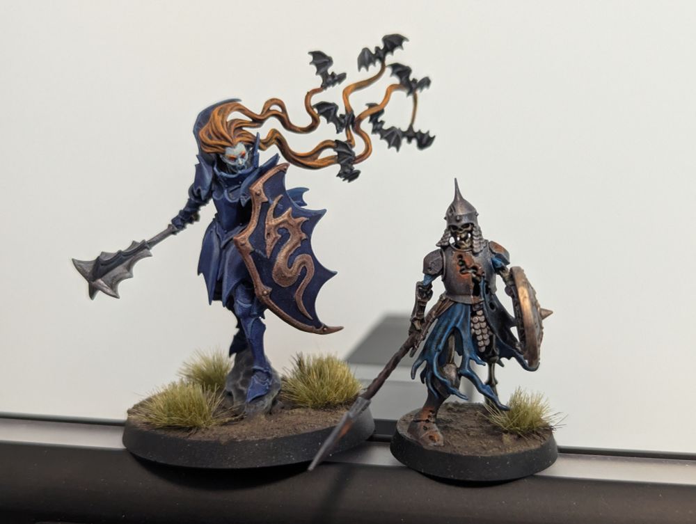Soulblight Gravelords vampire lord on foot and a Deathrattle Skeleton with spear. They're painted up in a variety of dark blues and bronze, with rusty iron equipment for the skeleton. 