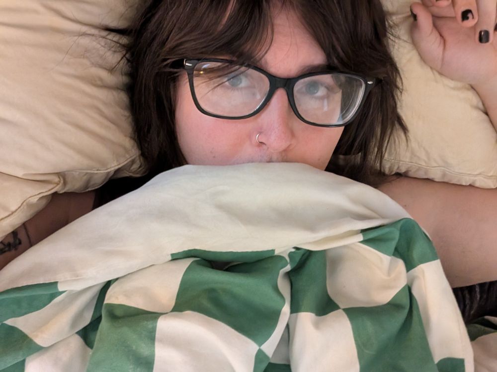 an absolute cutie lays in bed ready to take a nap