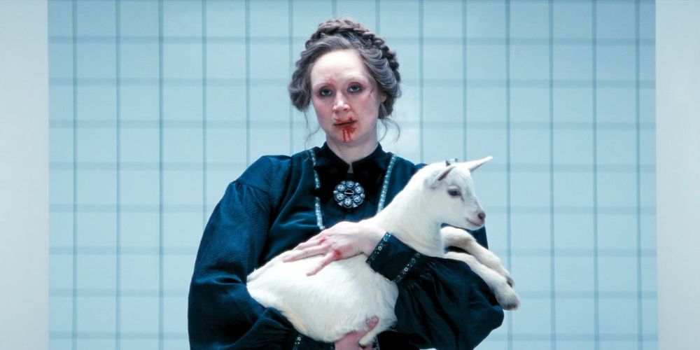 Big lady holding baby goat