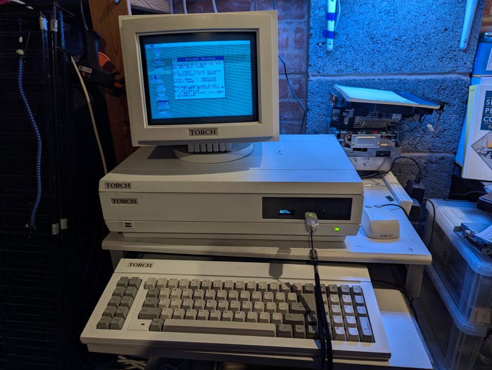 A picture of the Torch Triple X in its case with Gotek floppy drive and small Sony monitor. The kernel window is displayed but everything is in low resolution for no explicable reason...