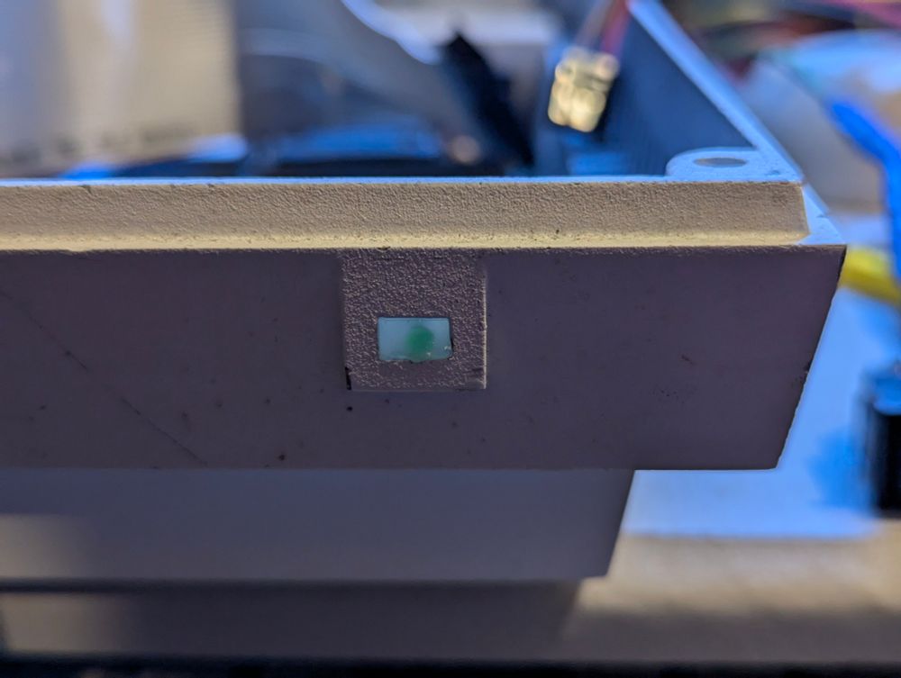 A picture of the Torch power LED. The hole has been filled and a 2mm green LED inserted before the glue cooled.