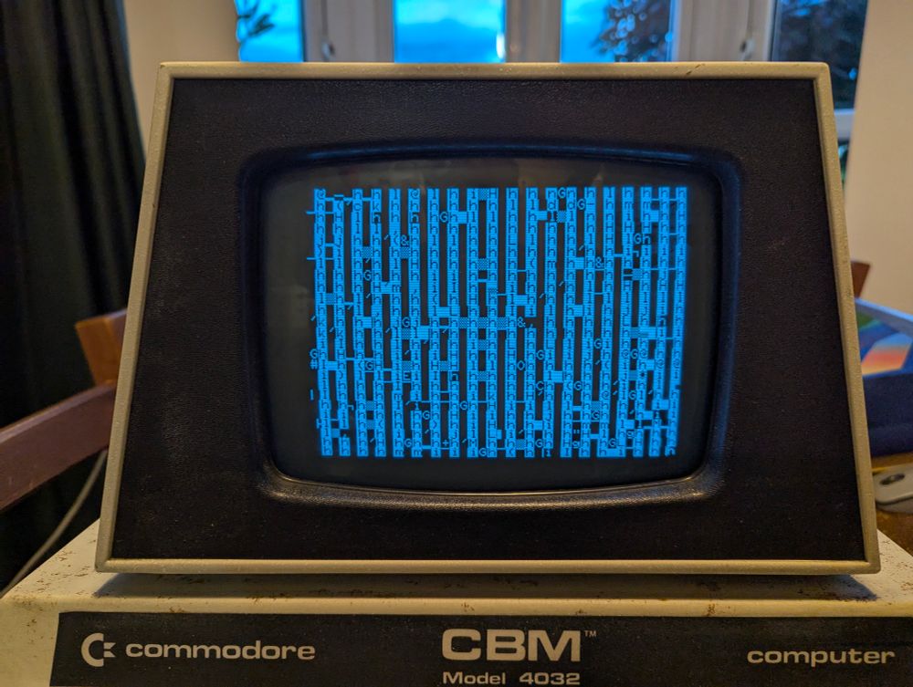 A picture of the PET screen. The display shows random characters on slide white and black lines in columns.