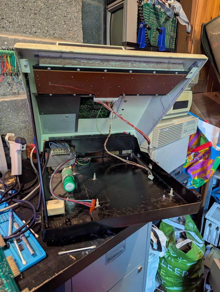 The inside of Rusty with his motherboard removed. A large green capacitor is to the left, behind is the main transformer of the power supply. 