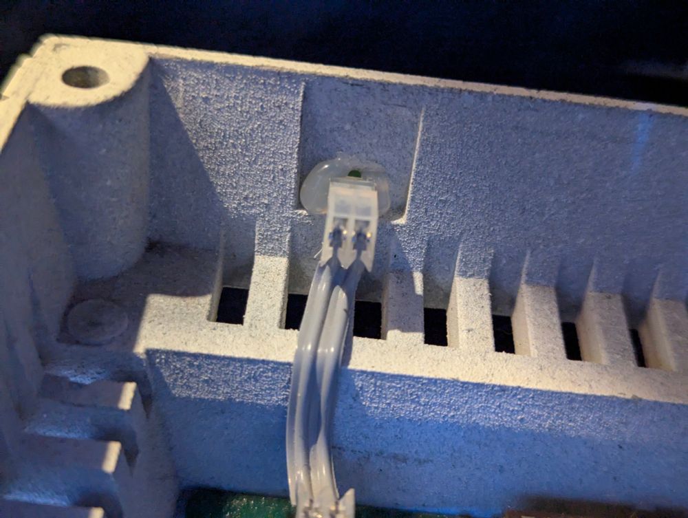 The rear of the Torch power LED. A small grey cable extends from the motherboard to the LED. 