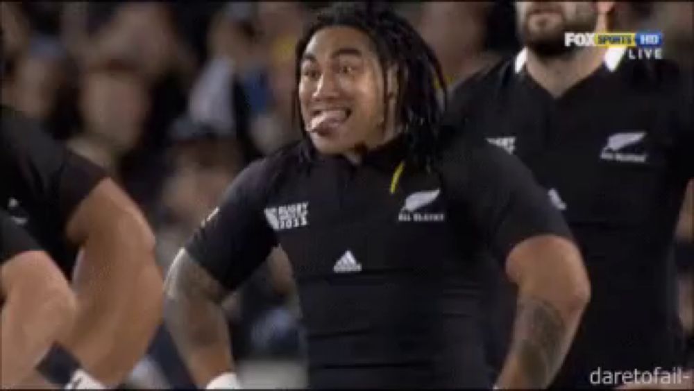 a man in a black all blacks jersey is making a face