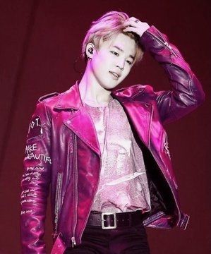 Jimin in hot pink leather jacket, brushing back his blonde bangs with one hand