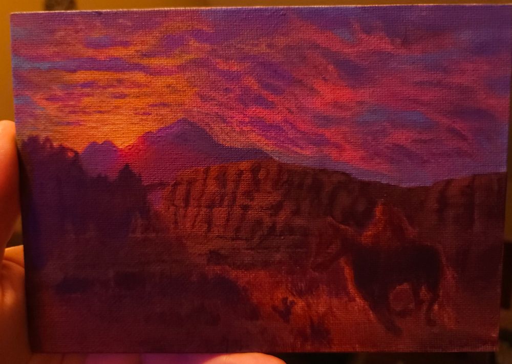 Work in progress acrylic painting of a horse and rider in the vibrant sunrise or sunset hues of a western scene. The sun sits at the horizon illuminating the sky in orange, pink, and purple, as reddish pink rays of light kiss the land, with one bright beam shining thru canyon walls and arches to illuminate a patch of desert scrub and sand as a the (very rough sketch of a ) horse and rider pass through the light in the foreground

all 3 photographs depict the same painting in slightly different room lighting conditions 