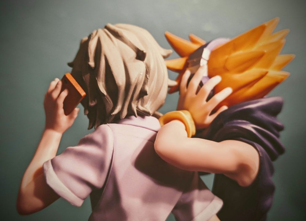 "The World Ends With You" Joshua and Neku figures posed together, standing facing away. The pose with Neku's arm looking like it's draped across Joshua's shoulder is meant to convey intimacy.