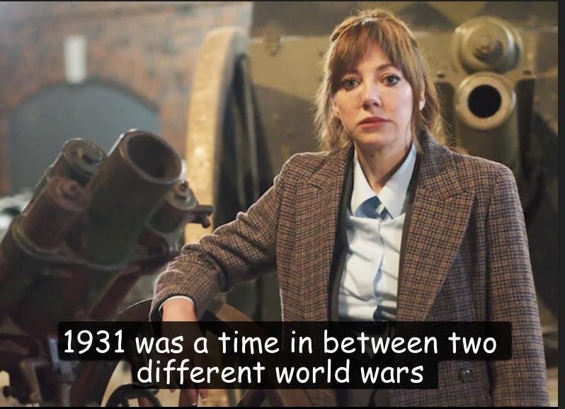 Philomena Cunk in a room full of armaments. "1931 was a time in between two different world wars"