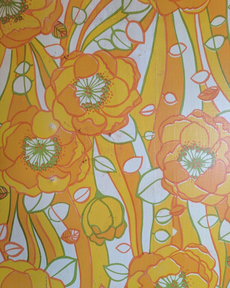 Close-up of vinyl wallpaper with orange flowers.