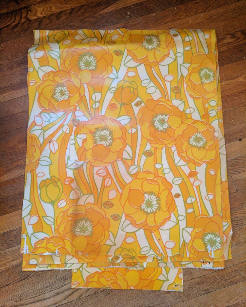 Vinyl wallpaper sheets with orange flowers.