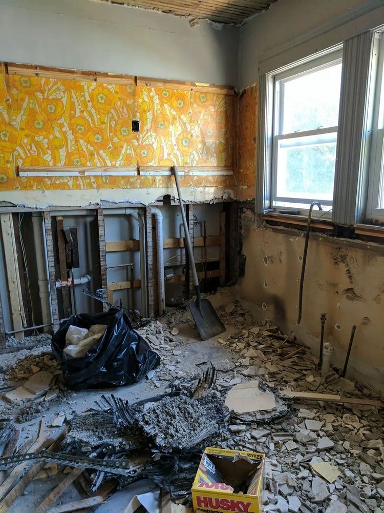 Destroyed kitchen rubble and vinyl wallpaper.