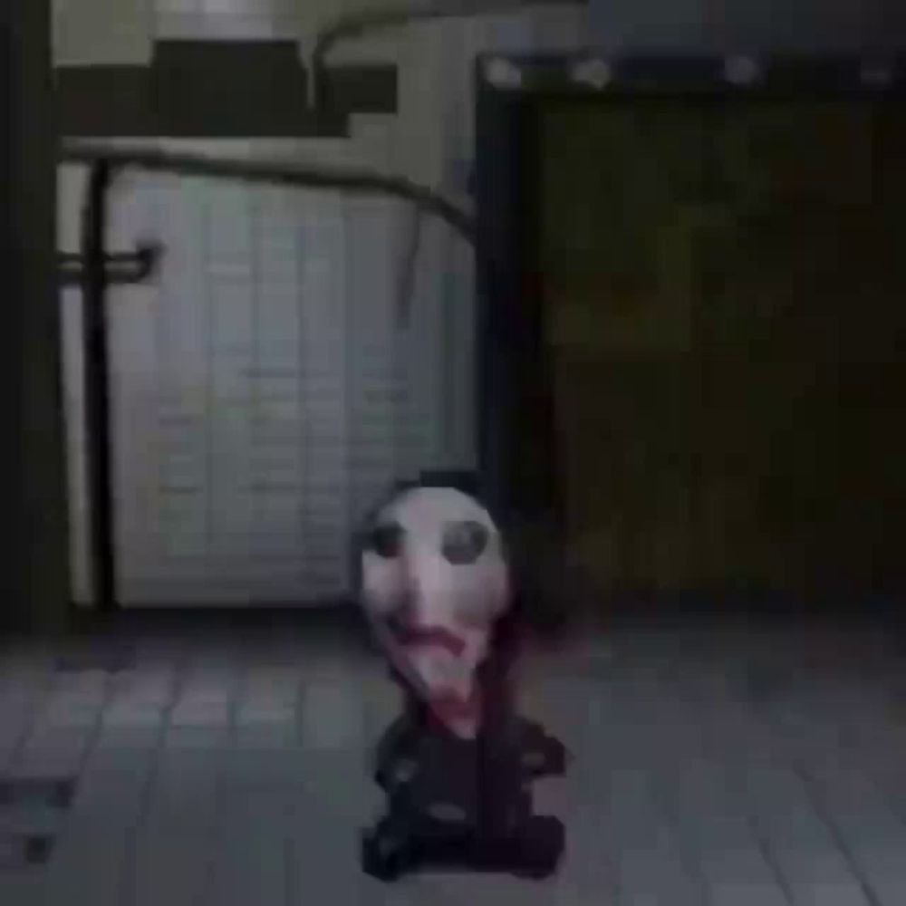 a puppet with a bloody face is sitting on the floor