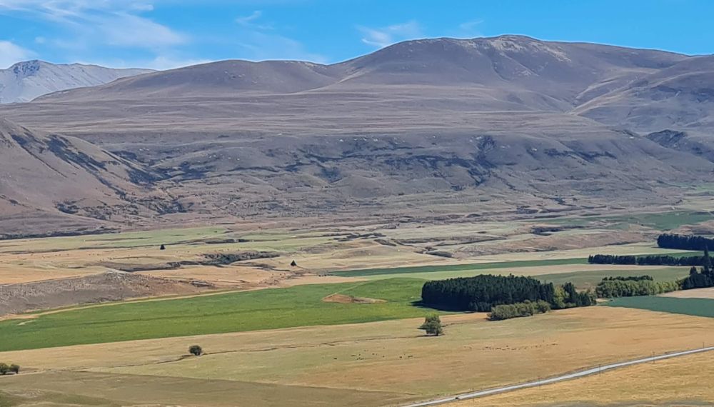 Apparent river terraces (straight lines) high on the hill side show where the glacier flowed.
