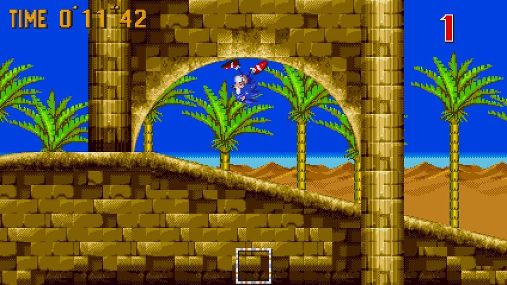 A screenshot from "Sonic the Hedgehog 3" of Sonic running through a loop in a desert level known as "Desert Palace." 