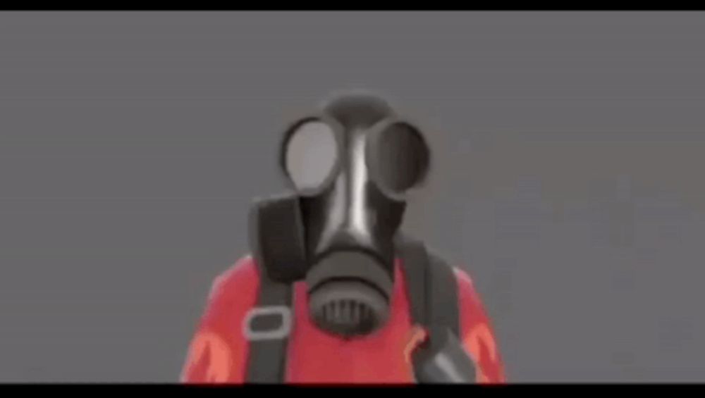 a person wearing a gas mask and a red shirt with the letter r on it .