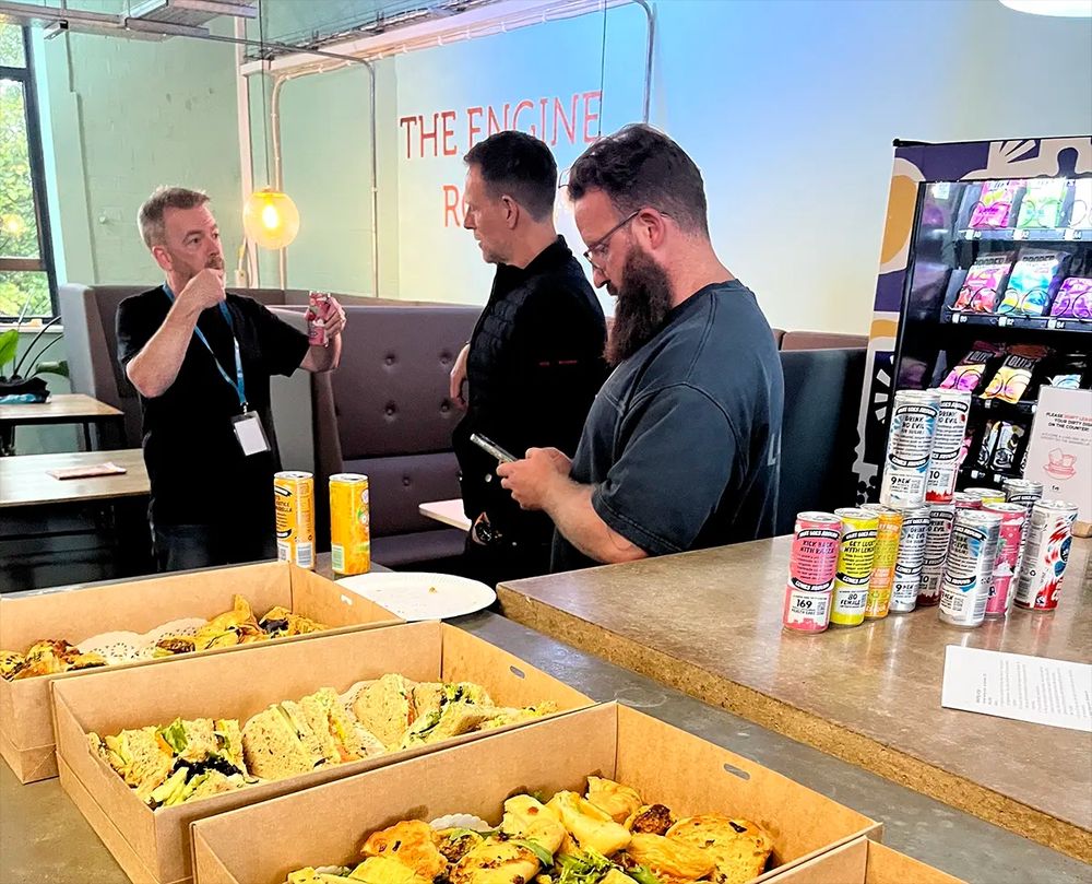 Dave animatedly chatting to a couple of attendees about something very exciting, apparently.