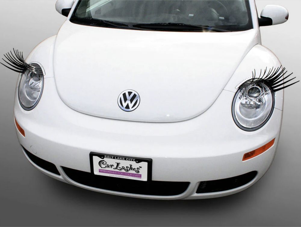 picture of a white vw beetle with carlashes installed over the headlights