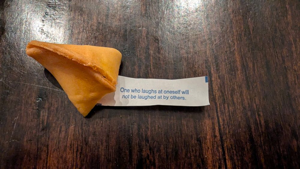 Fortune cookie that reads "One who laughs at oneself will not be laughed at by others" 
