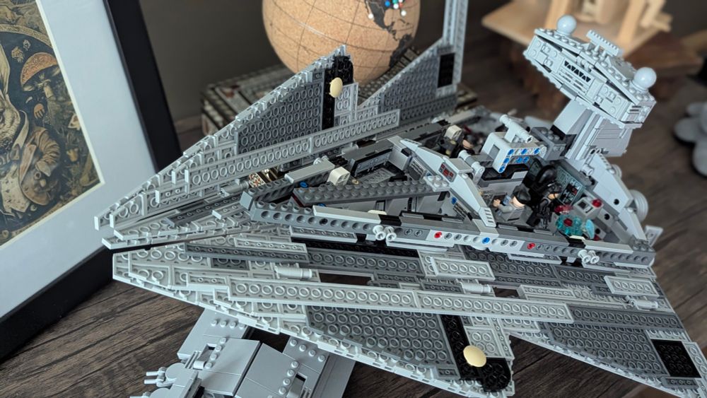 Close-up of a fully constructed grey Lego Star Destroyer, showing exposed interior details and mini-figures.