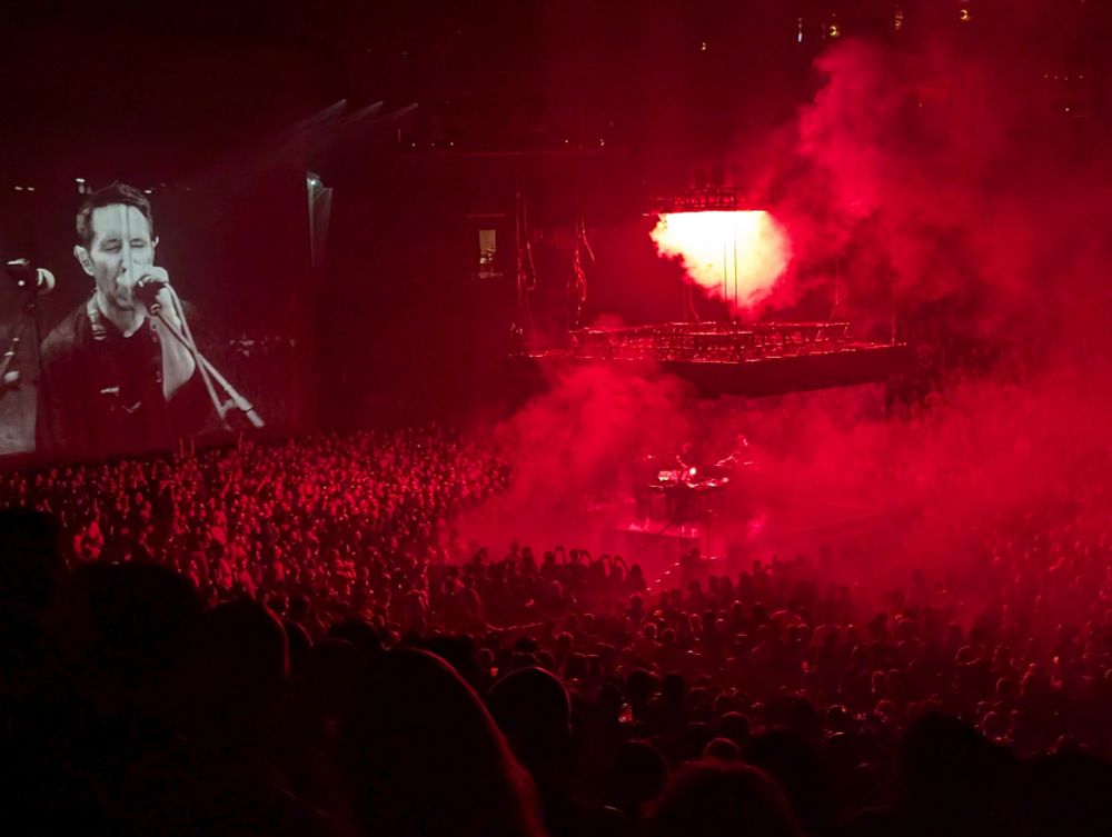 Nine inch nails at Barclays center. Red lights and smoke with a video screen with trent reznor on it