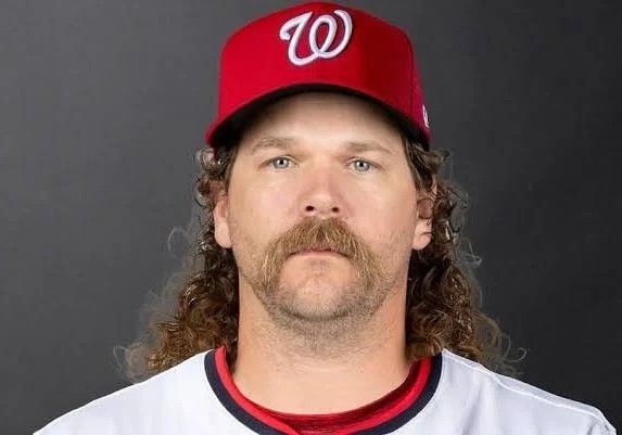 A picture of Andrew chafin with flowing curly hair and an Incredible handlebar mustache.