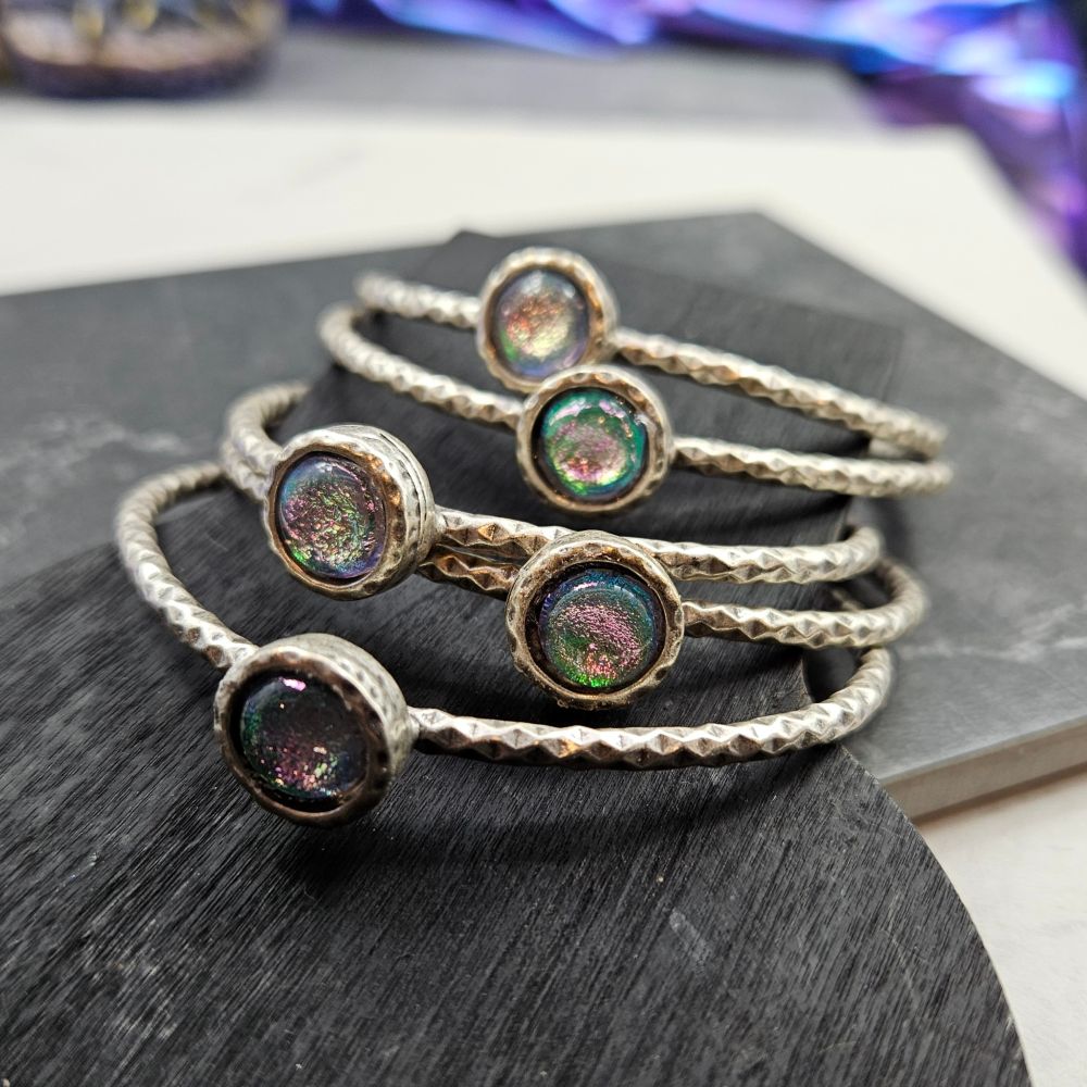 5 silver bangles with dichroic glass centers 