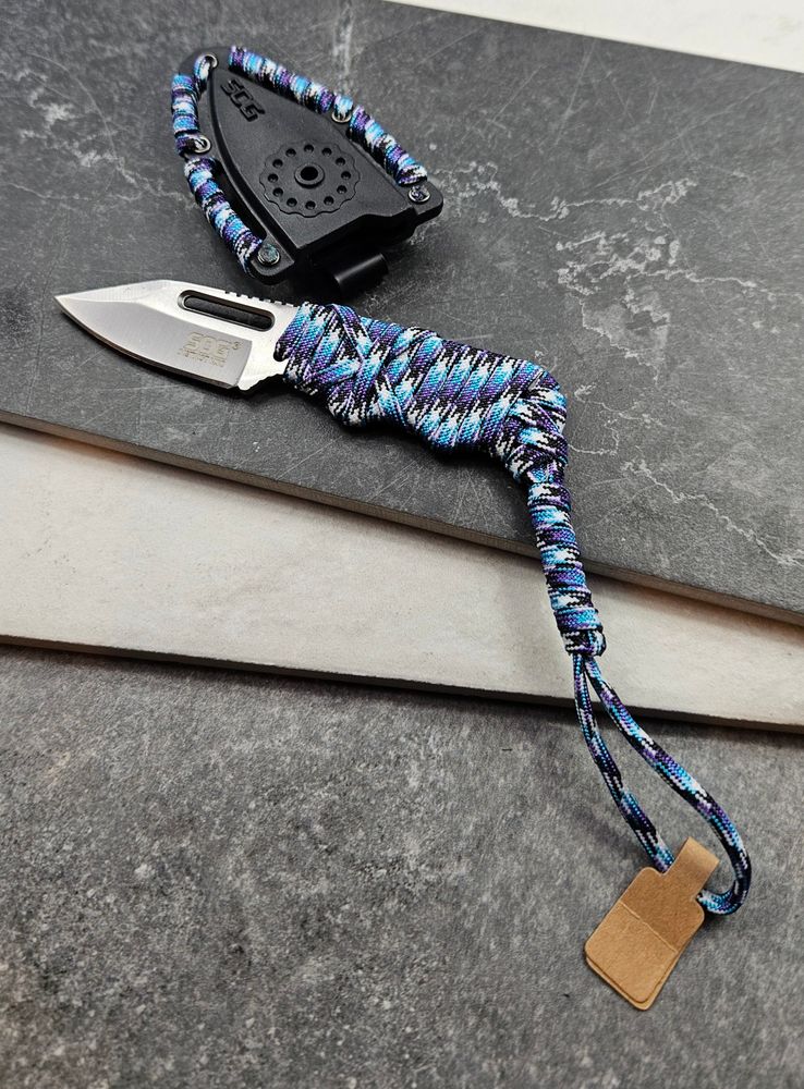 A paracord wrapped pocket knife and sheath in blues and grays.
