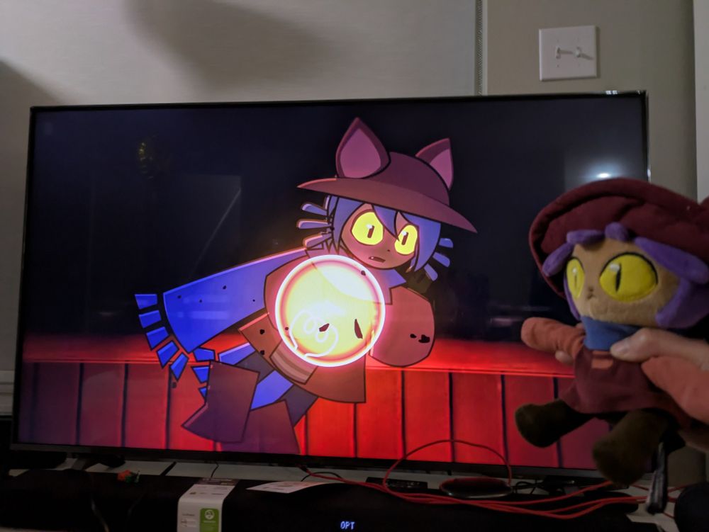 Niko plush pointing to a frame of Niko from Indie Cross episode 2