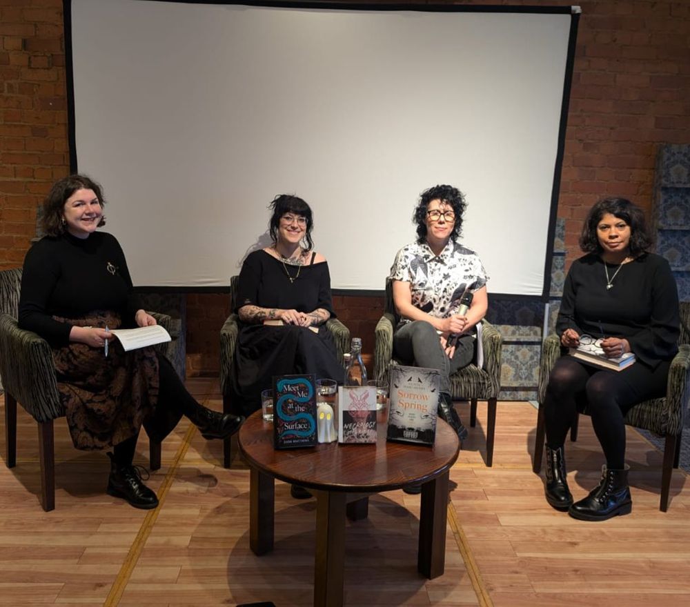 Jennifer Brough sitting with Jodie Matthews, Meg Ripley and Olivia Isaac-Henry on the stage. 