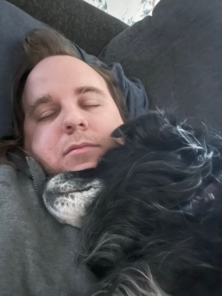 A man cuddling with his dog.