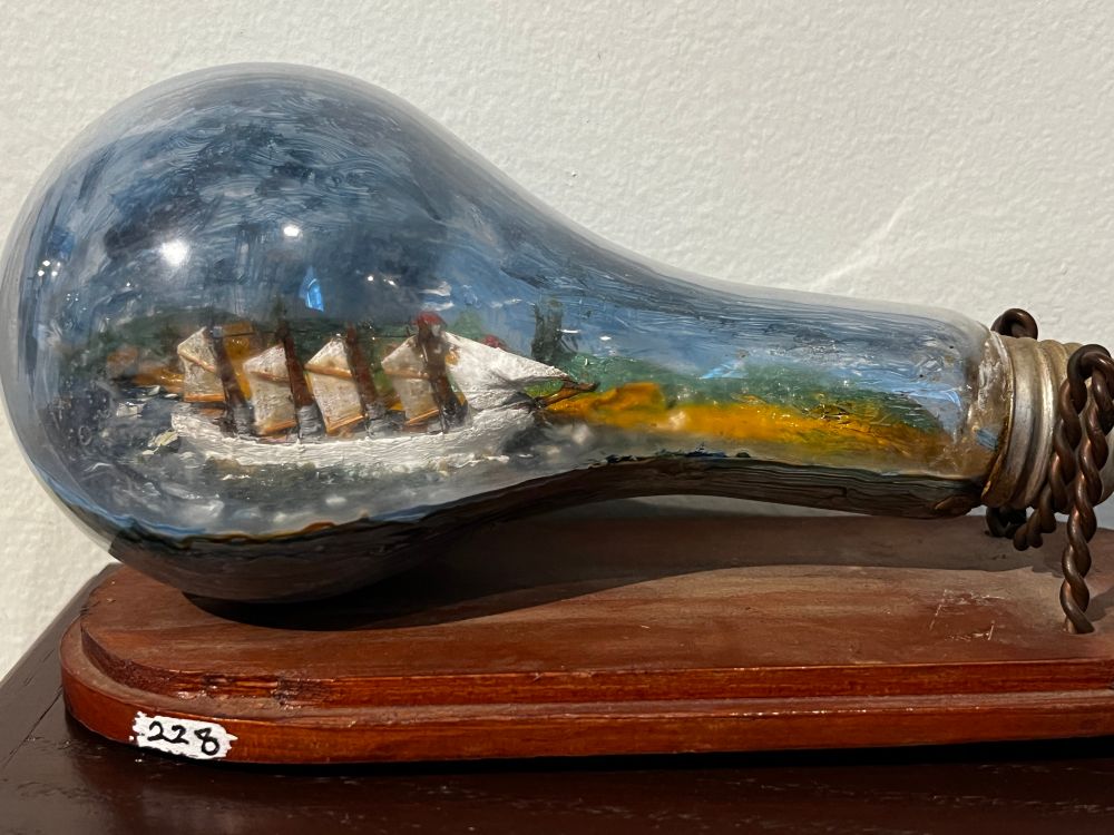 A painted model ship in glass bottle