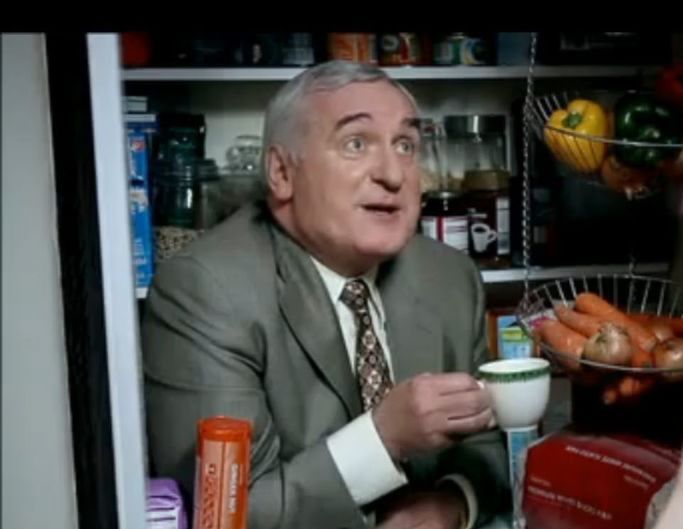 Bertie hiding in a cupboard having a cup of tea